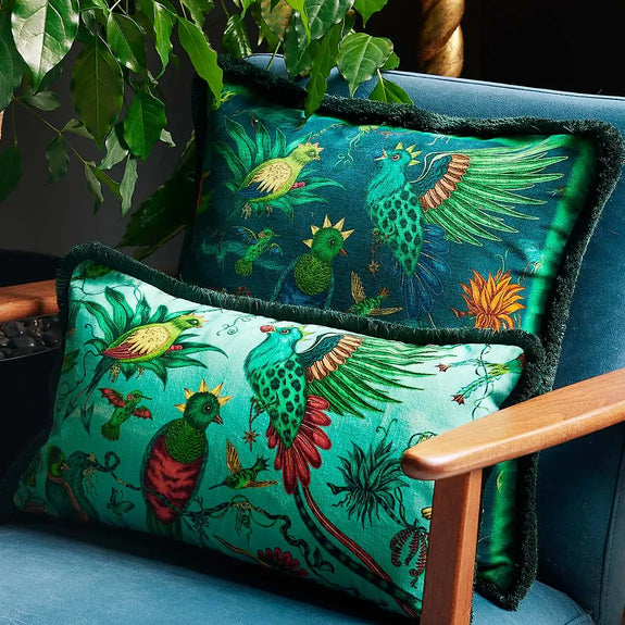 Teal | Detail photo of Quetzal Luxury Velvet Bolster Cushion in Aqua and Square in Teal on a chair
