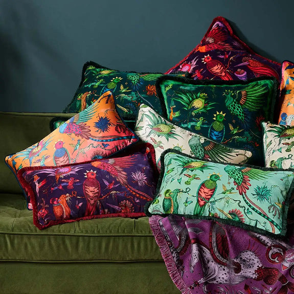 Violet | Group photo of Quetzal Luxury Velvet and SIlk Cushions on a green sofa designed by Emma J Shipley in London inspired by Costa Rica's Cloud Forest