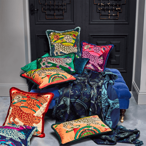 Forest | The Snow Leopard Luxury Velvet Cushion in Forest, featuring enchanting blues, striking greens and flame reds with opulent ruche fringing. Designed by Emma J Shipley, inspired by Dante’s Inferno and Paradiso from the 14th century and Ingmar Bergman’s film “The Seventh Seal
