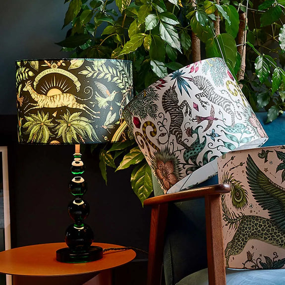The small Zambezi Silk Lampshade has the leaping Gazelle running across the front of it with the banner over the top with the palm trees coming up through the base