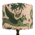 The Large Lynx Silk Lampshade with soft neutral pinks and enchanting lime greens running through the design, the lampshade designed by Emma J Shipley features a leaping Lynx cat with wings on the front amongst a forest of palm tress