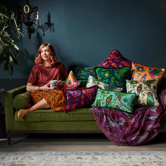 Teal | Group photo of Emma with Quetzal Luxury Velvet and SIlk Cushions on a green sofa designed by Emma J Shipley in London inspired by Costa Rica's Cloud Forest
