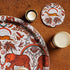 1 | 4 | Decorative coaster with an African gazelle design surrounded by tropical elements on a beige background