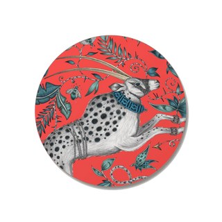 Four circular coasters with a gazelle design on a red background