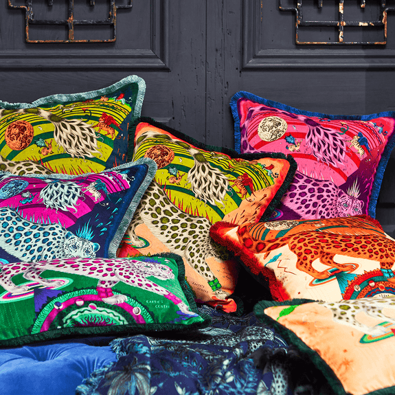 Flame | The Snow Leopard Luxury Velvet Cushion in Flame, featuring vibrant oranges, flame reds and striking blues with opulent ruche fringing. Designed by Emma J Shipley, inspired by Dante’s Inferno and Paradiso from the 14th century and Ingmar Bergman’s film “The Seventh Seal”