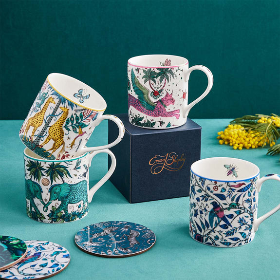 Zambezi Dinner Plates | The Explorer Mugs designed by Emma J Shipley, crafted in fine bone china by skilled artisans in Stoke on Trent UK, hand decorated with an exquisitely detailed and colourful design featuring leopard spotted elephants, a leaping gazelle, soaring hornbills in layers of teal, greens and neutrals, part of the Fine China Dining collection