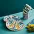 Side plates and mugs designed by Emma J Shipley, crafted in fine bone china by skilled artisans in Stoke on Trent UK, hand decorated with an exquisitely detailed and colourful artwork with giraffes and detailed foliage in yellow, blues and greens - part of the Fine China Dining collection