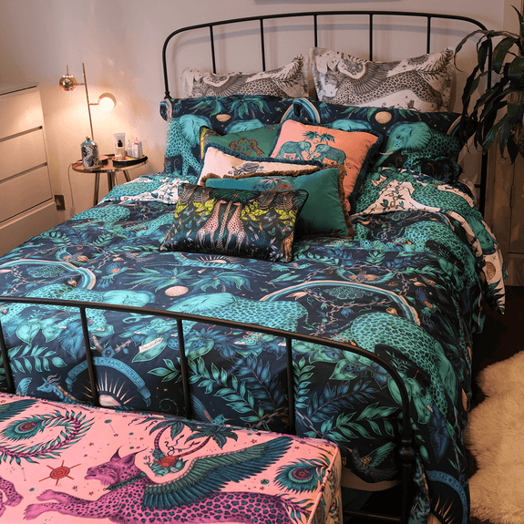 Teal/White | Emmas bed with the homeware bedding on the with silk cushions, velvet cushions, duvet cover, pillowcases and a lynx ottoman at the end of the bed