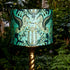 Peacock | Odyssey Silk Lampshade - Large in Peacock, designed by Emma J Shipley.  This intricate hand-drawn design was inspired by the Hellenistic period, the gods and goddesses of Grecian mythology and Emma’s travels to Greece’s ancient sites.  