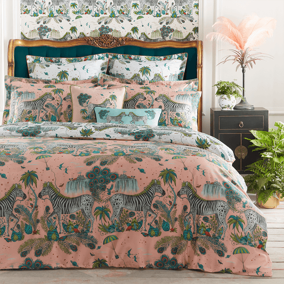 Pink/White | Transform your bedroom into a surreal African landscape with the Lost World Oxford Pillowcase in pink/white, designed by Emma J Shipley. Featuring a striking scene of creatures including  Peacock tailed Zebras, Palm trees and parachutes.