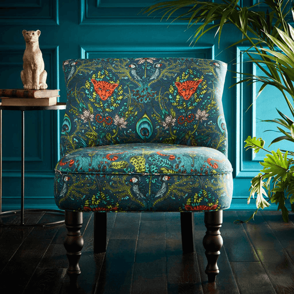 Navy | A lifestyle shot of the Amazon Navy Langley chair, showing the magical design and luxurious Teal colour, designed by Emma J Shipley with Clarke & Clarke
