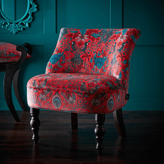 Red | The Emma J Shipley for Clarke & Clarke Amazon Langley Chair is a bold statement piece of luxury furniture, featuring a scene of jungle animals across a red velvet background