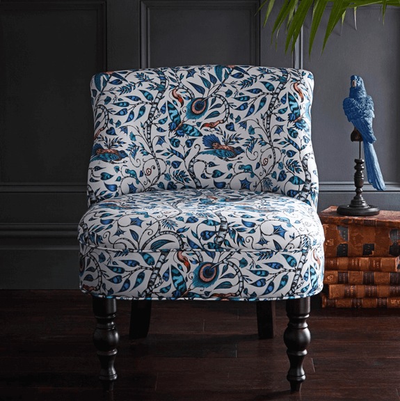 Blue | Exotic birds, creatures and foliage twist around each other in this bold occasion chair designed by Emma J Shipley for Clarke & Clarke
