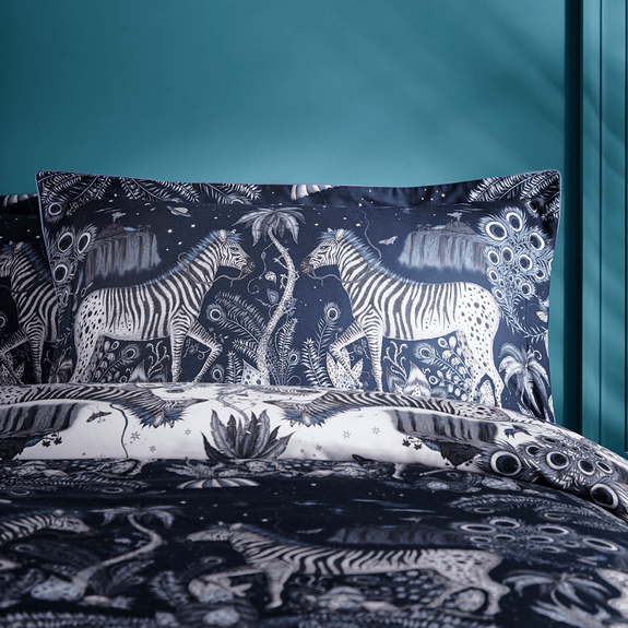 Navy/White | The Lost World Oxford Pillowcase in Monochrome Blue and navy is covered in Peacock tailed Zebras and mini floating parachutes, hand drawn by designer Emma J Shipley's travels. The hand-drawn illustration adorns the magical bedding set that guarantees to turn your bedroom into a maximalist dream world.