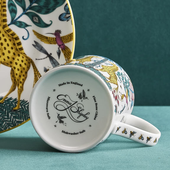 1 | Bottom of the Kruger Mug designed by Emma J Shipley, crafted in fine bone china by skilled artisans in Stoke on Trent UK, hand decorated with an exquisitely detailed and colourful artwork with giraffes and detailed foliage in yellow, blues and greens - part of the Fine China Dining collection