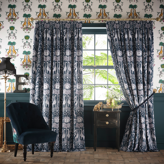 A drawn back style of the Kruger Navy Velvet Ready made curtains designed by Emma J Shipley in collaboration with Clarke & Clarke