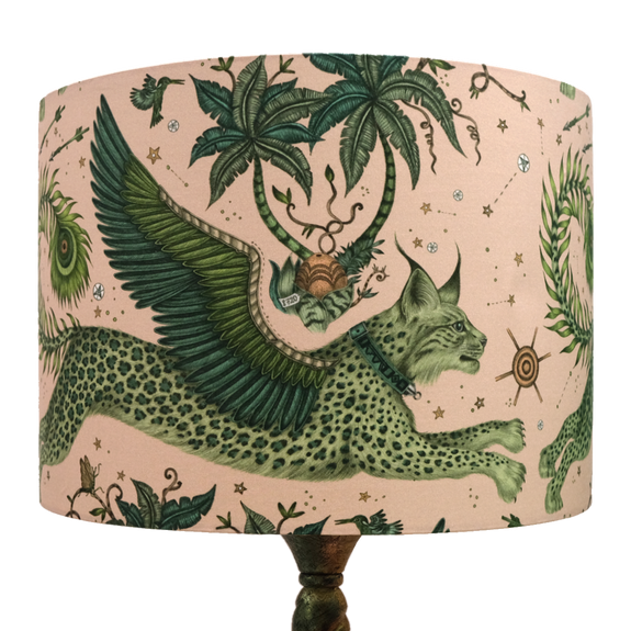 The Large Lynx Silk Lampshade with soft neutral pinks and enchanting lime greens running through the design, the lampshade designed by Emma J Shipley features a leaping Lynx cat with wings on the front amongst a forest of palm tress