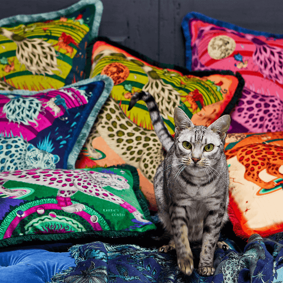 Ice | The Snow Leopard Luxury Velvet Cushion in Ice, featuring sstriking pinks and vibrant blues with opulent ruche fringing. Designed by Emma J Shipley, inspired by Dante’s Inferno and Paradiso from the 14th century and Ingmar Bergman’s film “The Seventh Seal”