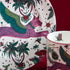 Details of the Lynx Side Plate designed by Emma J Shipley, crafted in fine bone china by skilled artisans in Stoke on Trent UK, hand decorated with an exquisitely detailed and colourful artwork with a Lynx, leaping through a starry night sky surrounded by magical creatures in pink, magenta and verdant green shades - part of the Fine China Dining collection