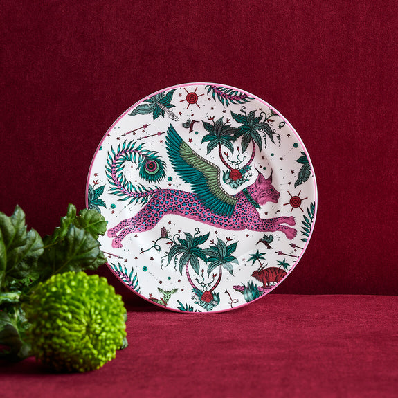 Lynx Side Plate designed by Emma J Shipley, crafted in fine bone china by skilled artisans in Stoke on Trent UK, hand decorated with an exquisitely detailed and colourful artwork with a Lynx, leaping through a starry night sky surrounded by magical creatures in pink, magenta and verdant green shades - part of the Fine China Dining collection