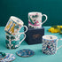 1 | Kruger, Lynx, Rousseau and Zambezi Mugs designed by Emma J Shipley, crafted in fine bone china by skilled artisans in Stoke on Trent UK, hand decorated with an exquisitely detailed and colourful artwork with giraffes and detailed foliage in yellow, blues and greens - part of the Fine China Dining collection