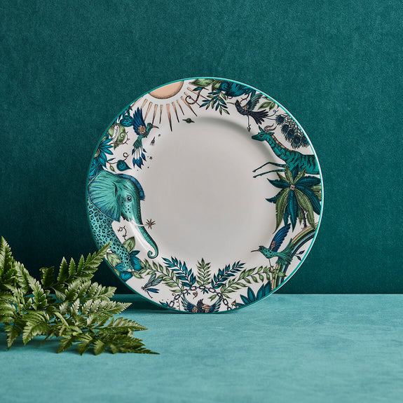Zambezi Dinner Plate designed by Emma J Shipley, crafted in fine bone china by skilled artisans in Stoke on Trent UK, hand decorated with an exquisitely detailed and colourful design featuring leopard spotted elephants, a leaping gazelle, soaring hornbills in layers of teal, greens and neutrals, part of the Fine China Dining collection