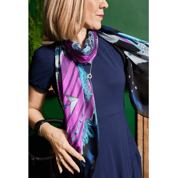 Winter - Ice | A closer look at the Winter scarf on Rachel showing the deep purples that run through the snow leopard design with all the little creatures and animals that run through the design